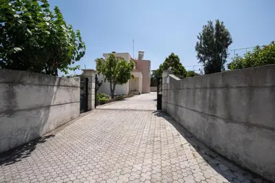 a stone pathway leading to a house with a fence at Villa Emerald in Asgourou