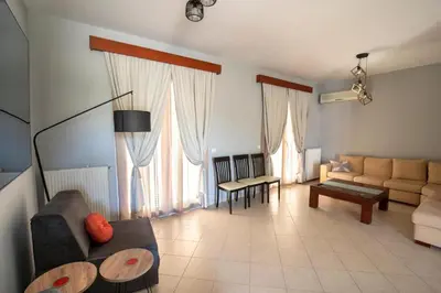 a living room with a couch and a table at Villa Emerald in Asgourou