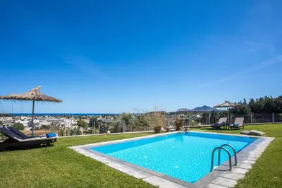 a swimming pool with a view of the ocean at High View Villa in Afantou