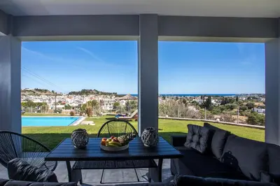 a living room with a table and a couch at High View Villa in Afantou