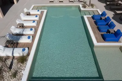 a swimming pool with lounge chairs and a resort at Prasonisi Lighthouse Boutique Hotel in Prasonisi