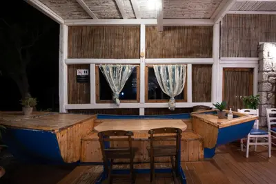a room with a table and a bath tub at Prasonisi Lighthouse Boutique Hotel in Prasonisi