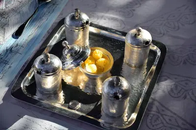 a silver tray with a bowl of food on it at Villa Melenos Lindos in Líndos