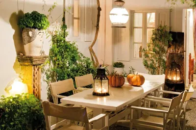 a dining room with a table and lots of plants at Villa Melenos Lindos in Líndos