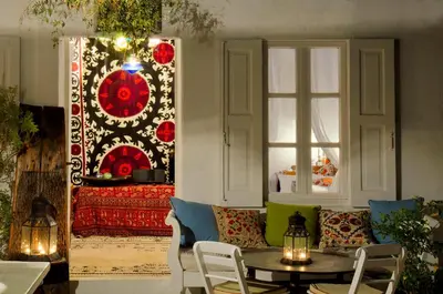 a room with a couch and a table and a window at Villa Melenos Lindos in Líndos