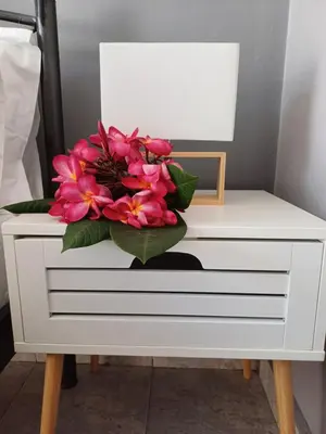 a white dresser with a pink flower on it at ZEUS Studios in Rhodes Town