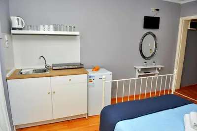 a small room with a sink and a bed at ZEUS Studios in Rhodes Town