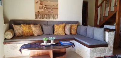a living room with a couch and a table at Mika's House in Halki