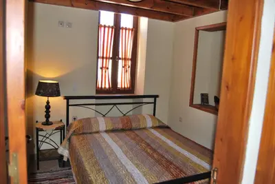 a bedroom with a bed and a lamp in it at Mika's House in Halki