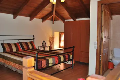 a bedroom with a bed and a bathroom at Mika's House in Halki