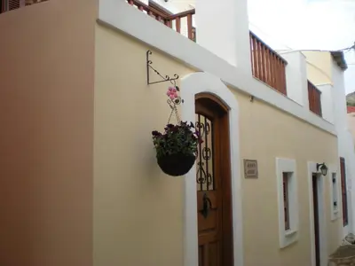 a flower pot hanging on the side of a building at Mika's House in Halki