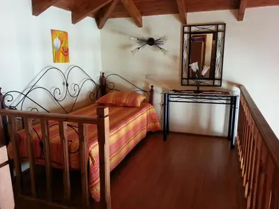 a bedroom with a bed and a mirror on the wall at Mika's House in Halki