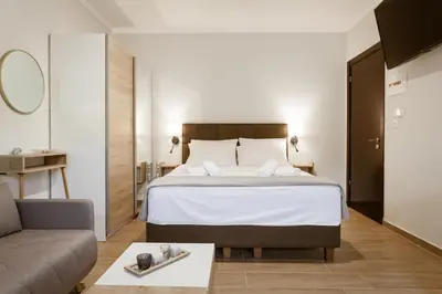 a hotel room with a bed and a couch at Serenity Studio for couples in Rhodes Town