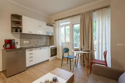 a kitchen and living room with a table and chairs at Serenity Studio for couples in Rhodes Town