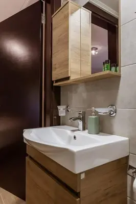 a bathroom with a white sink and a mirror at Serenity Studio for couples in Rhodes Town