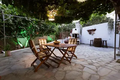 a wooden table and chairs on a patio at Serenity Studio for couples in Rhodes Town