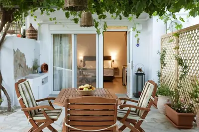 a wooden table and chairs with a bowl of fruit on it at Serenity Studio for couples in Rhodes Town