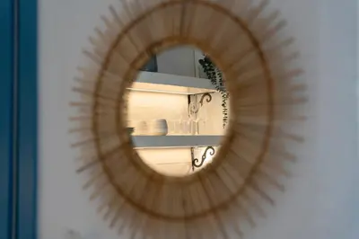 a mirror reflection of a shelf in a room at Mosaic Luxury Home in Rhodes Town