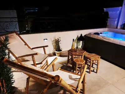 a group of chairs and a table and a swimming pool at Mosaic Luxury Home in Rhodes Town