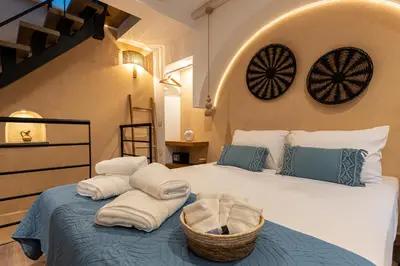 a bedroom with a bed with towels on it at Mosaic Luxury Home in Rhodes Town