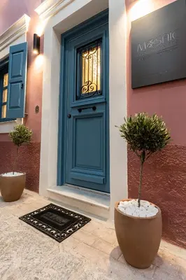 a blue door with two potted plants in front of it at Mosaic Luxury Home in Rhodes Town