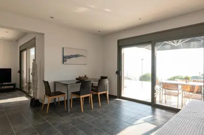 a dining room with a table and chairs at Villa Katerina in Líndos