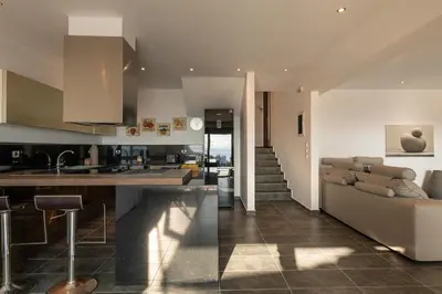 a kitchen and a living room with a couch at Villa Katerina in Líndos