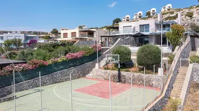 a tennis court on the side of a house at Villa Katerina in Líndos