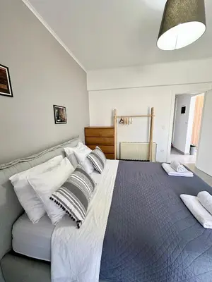 a bedroom with a large bed with pillows on it at Luxury spacious apartment in the heart of the city in Rhodes Town