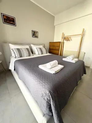 a bedroom with a large bed with two towels on it at Luxury spacious apartment in the heart of the city in Rhodes Town