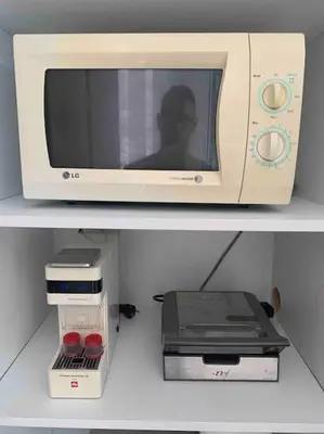 a microwave sitting on top of a shelf at Luxury spacious apartment in the heart of the city in Rhodes Town