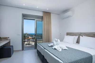 a hotel room with a bed with a towel on it at Madi Villa in Faliraki