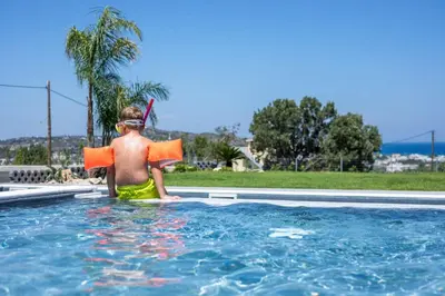 a young boy wearing an life vest and an life preserver at Madi Villa in Faliraki