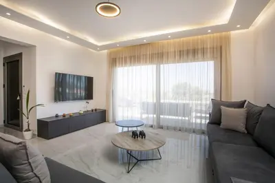 a living room with a couch and a table at Madi Villa in Faliraki