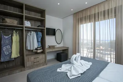 a bedroom with a bed with towels on it at Madi Villa in Faliraki