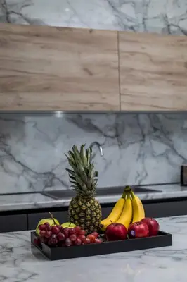 a tray of fruit on a counter with a pineapple and bananas at Madi Villa in Faliraki