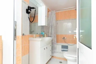 a bathroom with a sink and a toilet and a shower at ALMI Traditional House in Koskinou