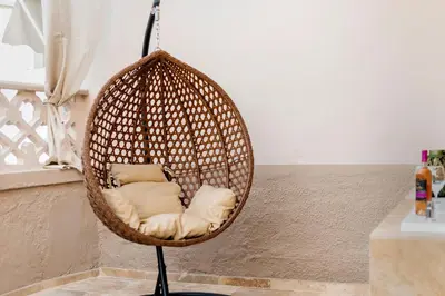 a hanging rattan chair in a room at ALMI Traditional House in Koskinou