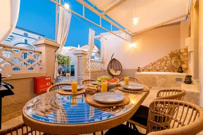 a dining room with a glass table and chairs at ALMI Traditional House in Koskinou