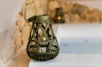a green vase sitting on top of a table at ALMI Traditional House in Koskinou