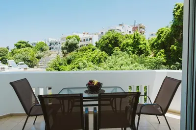 a table and chairs on a balcony with a view at namaste in Rhodes Town