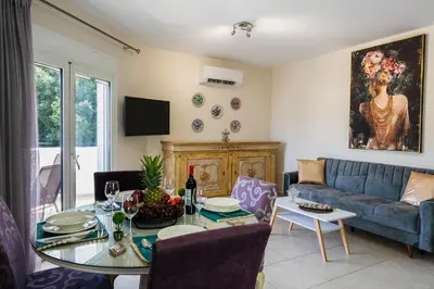 a living room with a blue couch and a table at namaste in Rhodes Town