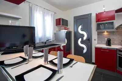 a kitchen with a table with a tv on it at Haraki Villas in Haraki