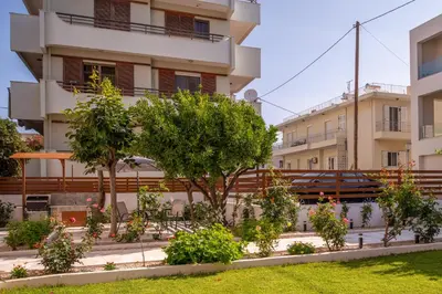 a building with trees and plants in front of it at Monte Smith Luxury Garden Apartment With Parking in Rhodes Town