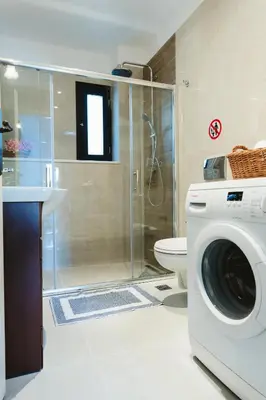 a bathroom with a shower and a washing machine at Anemoessa Mansion in Rhodes Town
