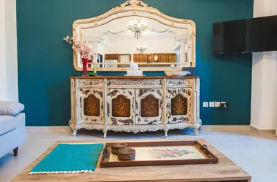 a living room with a dresser with a mirror at Anemoessa Mansion in Rhodes Town