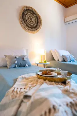 a room with a bed with a tray of food on it at Villas Mina and Studios in Gennadi
