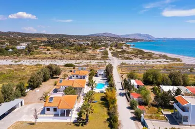 an aerial view of a beach with houses at Villas Mina and Studios in Gennadi
