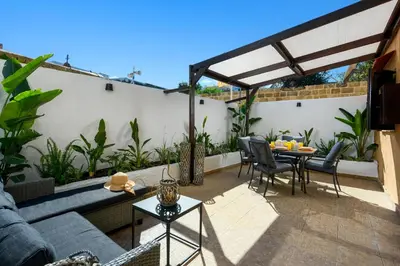 a patio with a couch and a table and chairs at Old Town Villa in Rhodes Town