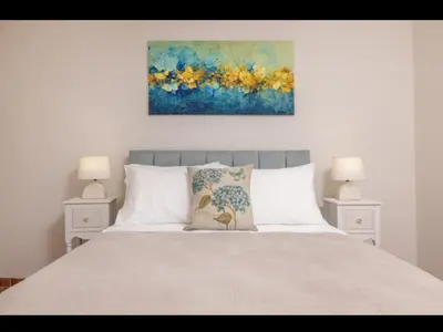 a bedroom with a bed with a painting on the wall at Nikolas Old Town in Rhodes Town